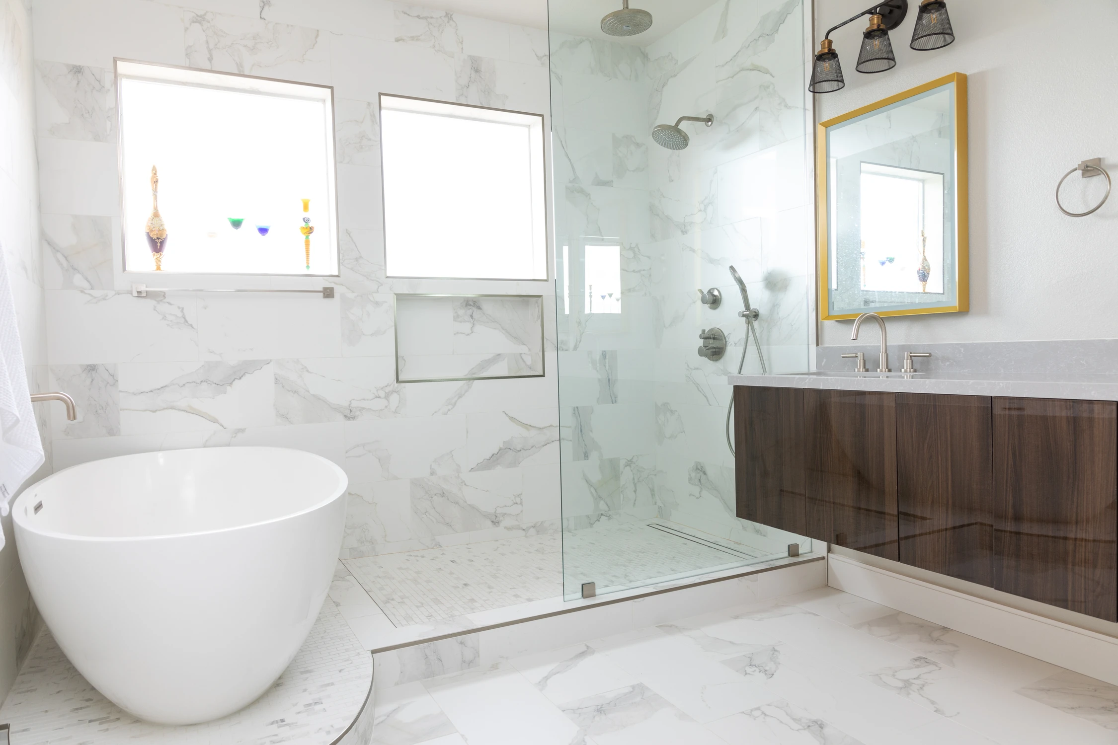 Bathroom with freestanding tub, glass shower, and walnut vanity