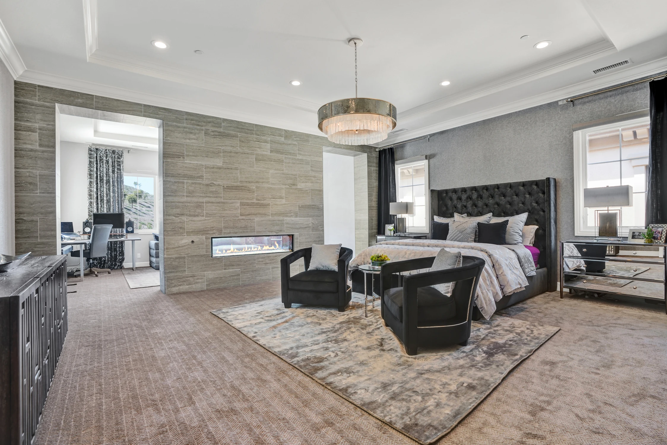 Master bedroom with sitting area and dark window drapery