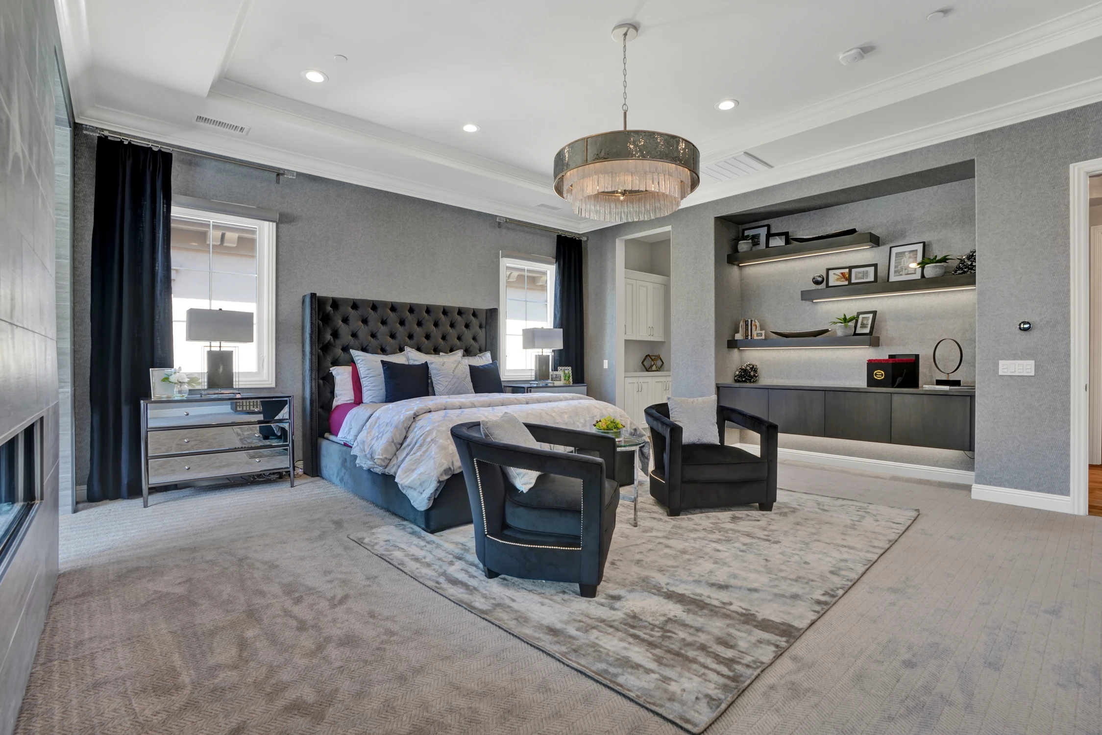 Master bedroom with bed, sitting area, and built-in shelves