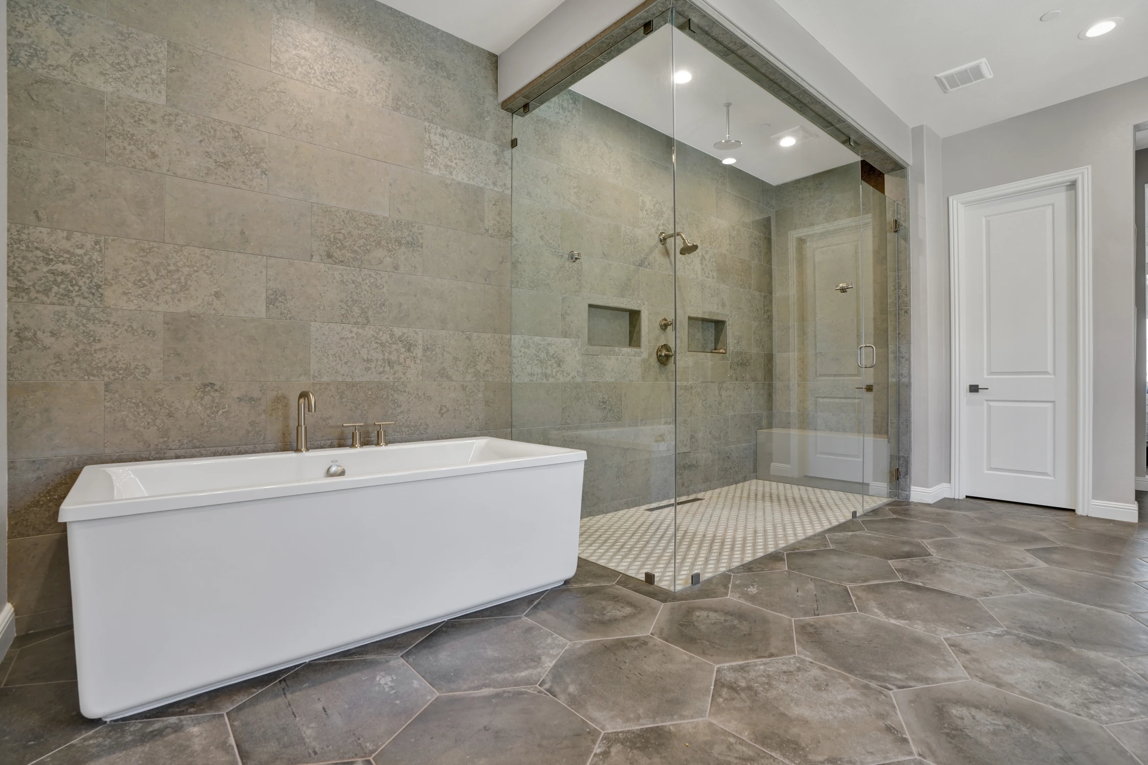 Master bathroom with freestanding tub and glass shower