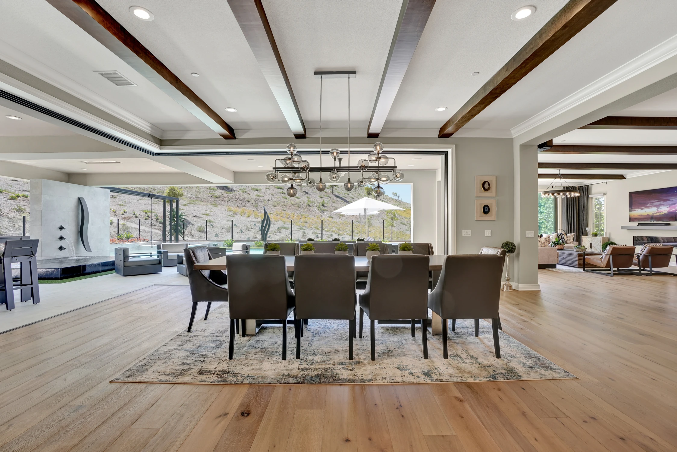 Dining room with exposed beams and round chandelier