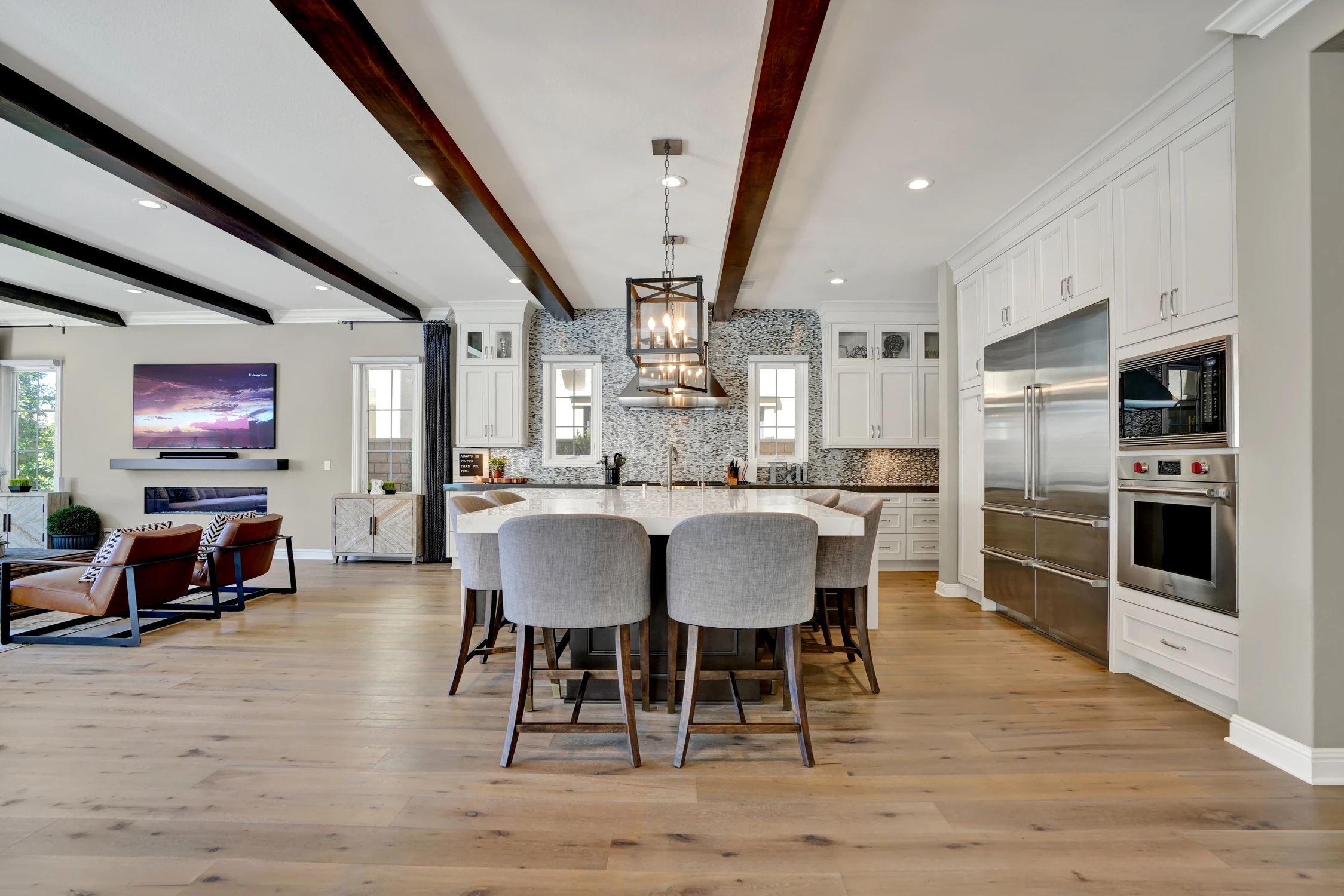 Open kitchen and dining room with exposed ceiling beams