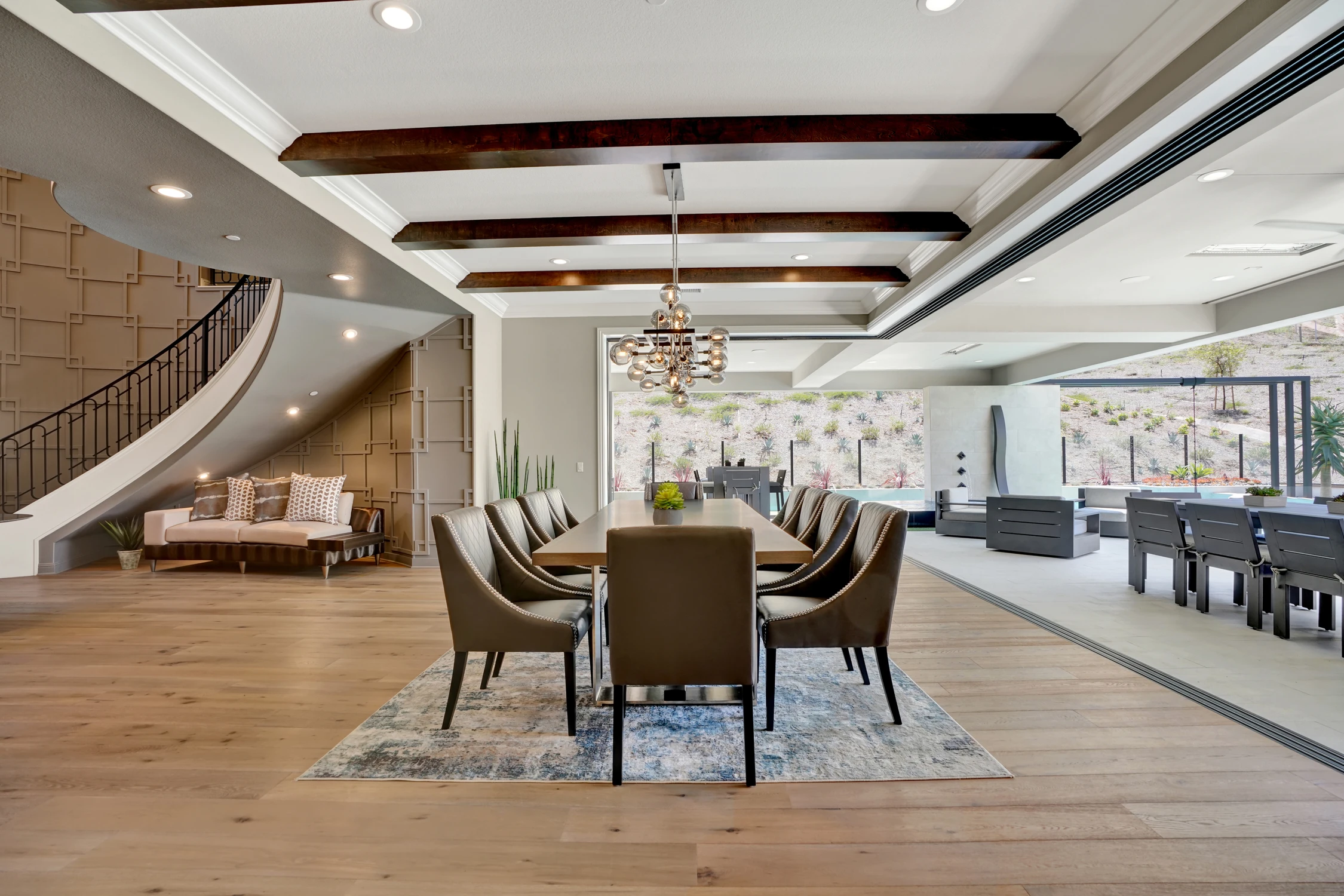 Dining room with exposed beams and open patio doors