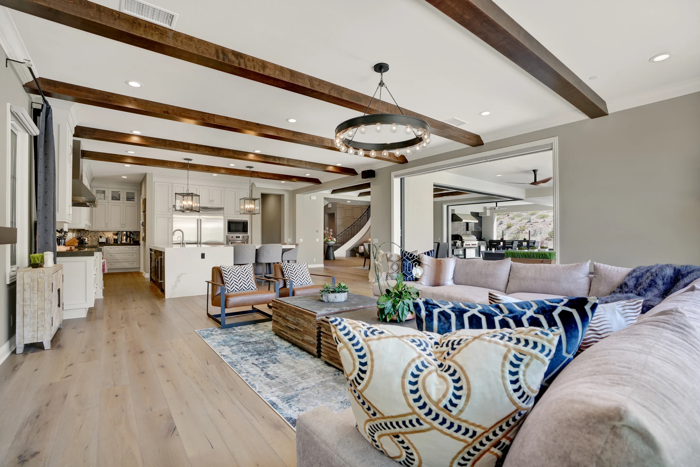 Living room with white sofa and television beneath exposed beams