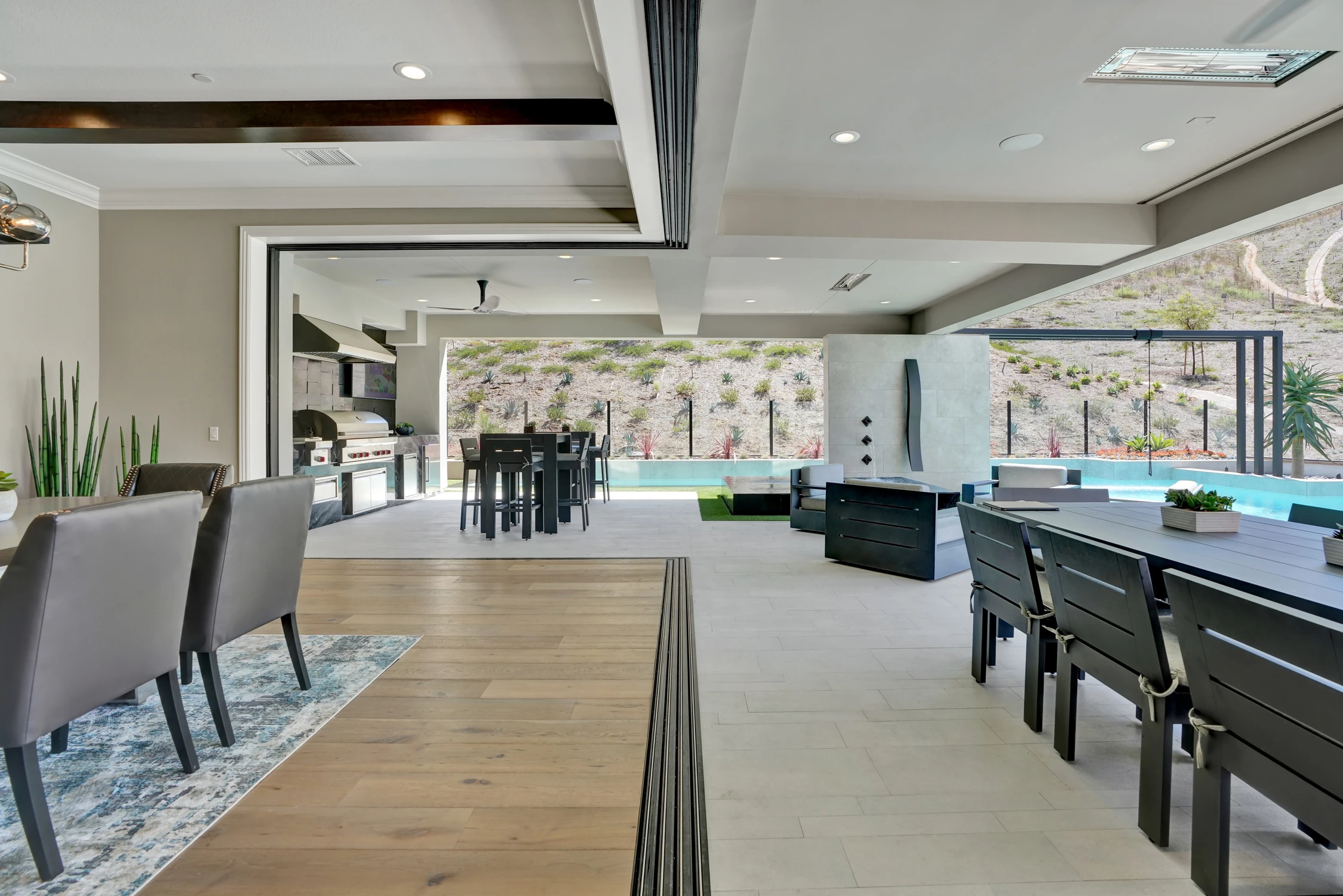 Outdoor dining table under covered patio with mountain view
