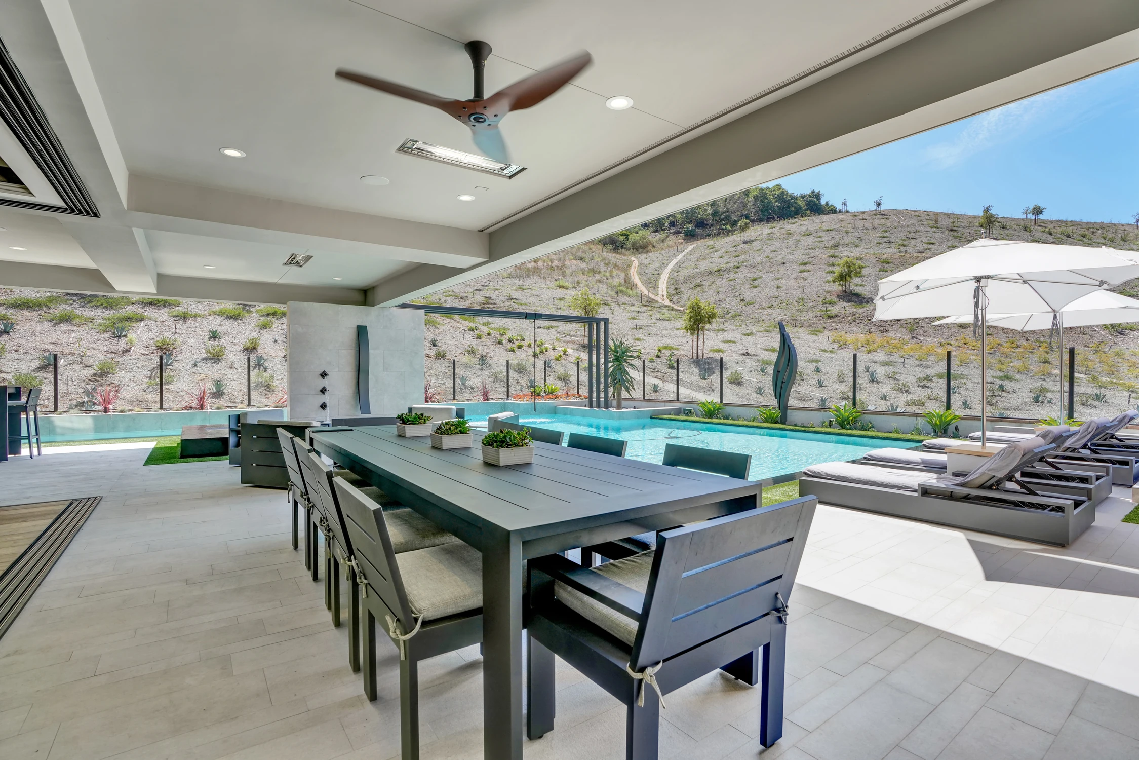 Covered outdoor bar with seating and mounted television