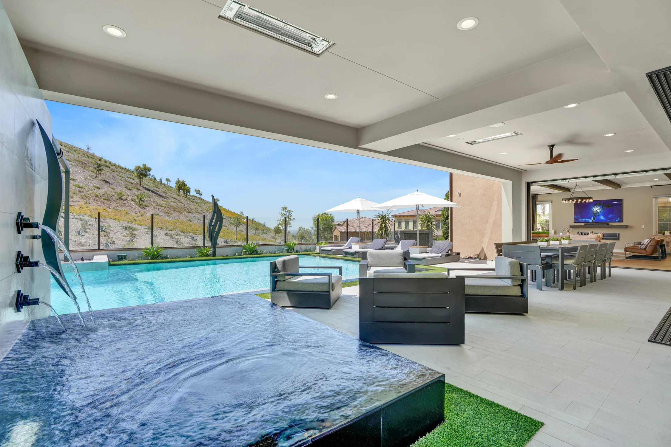 Backyard pool with house exterior and covered patio
