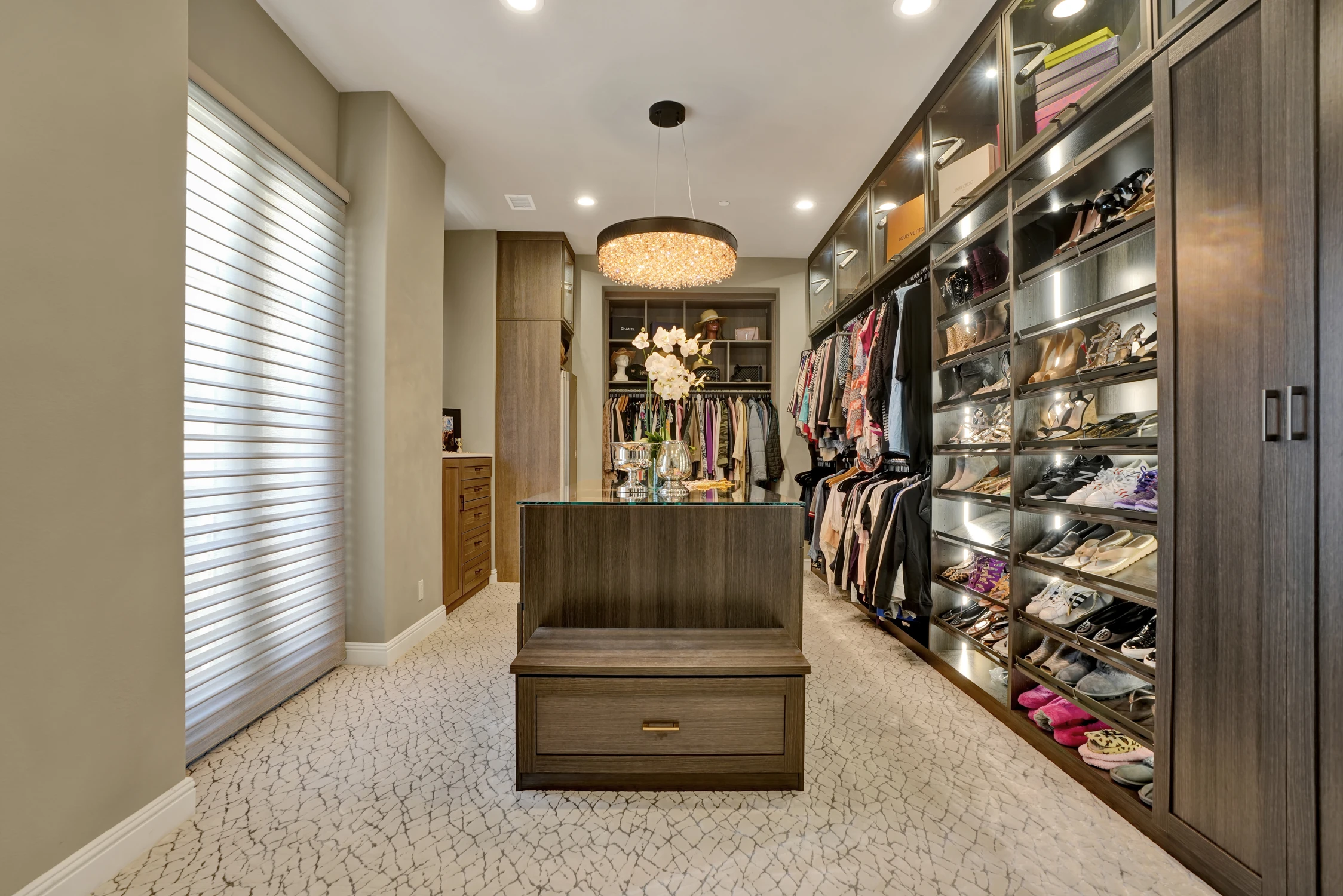 Walk-in closet with mirrored cabinets and clothing storage