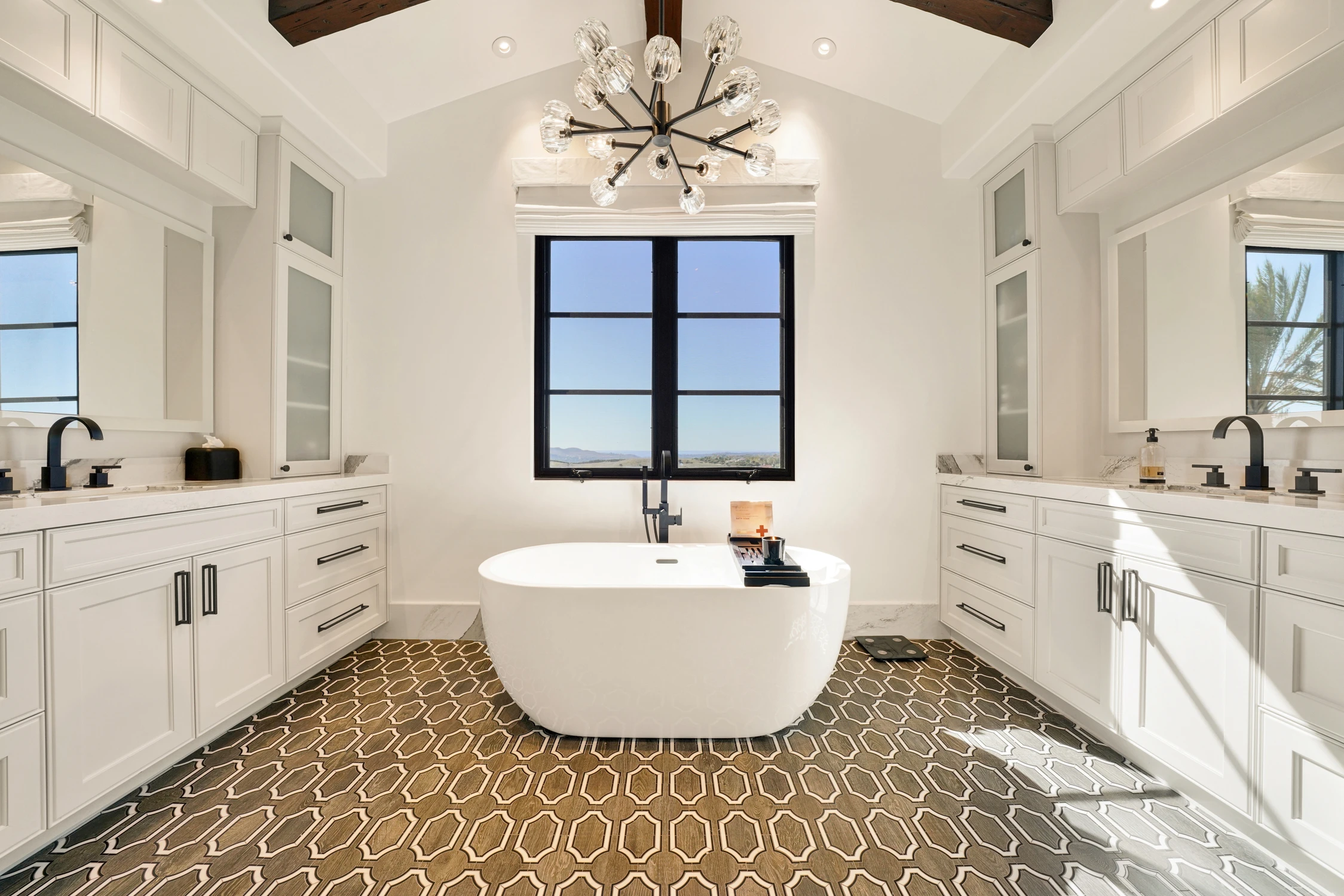 Freestanding tub against a black-framed window
