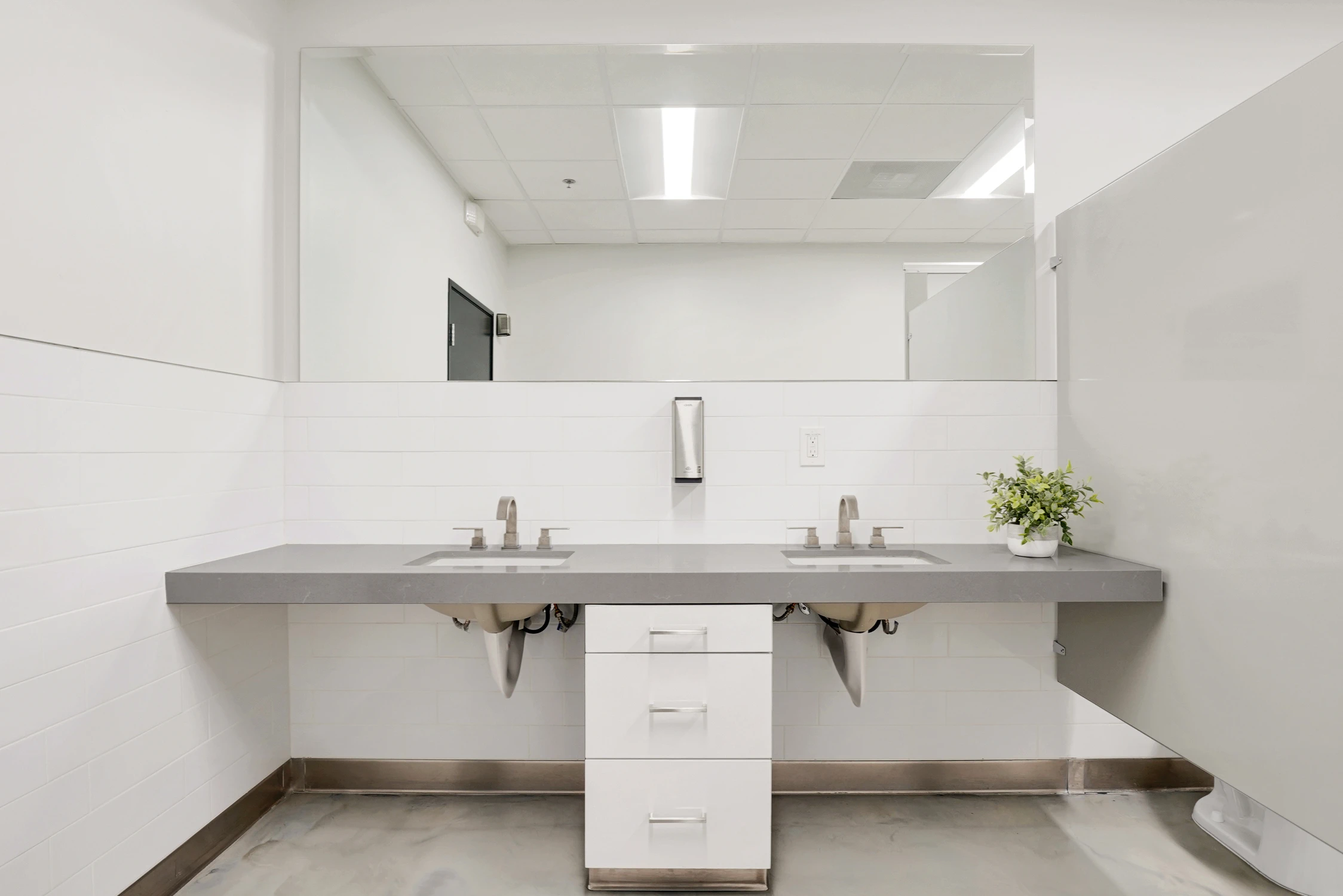 Double sink counter in bright commercial restroom