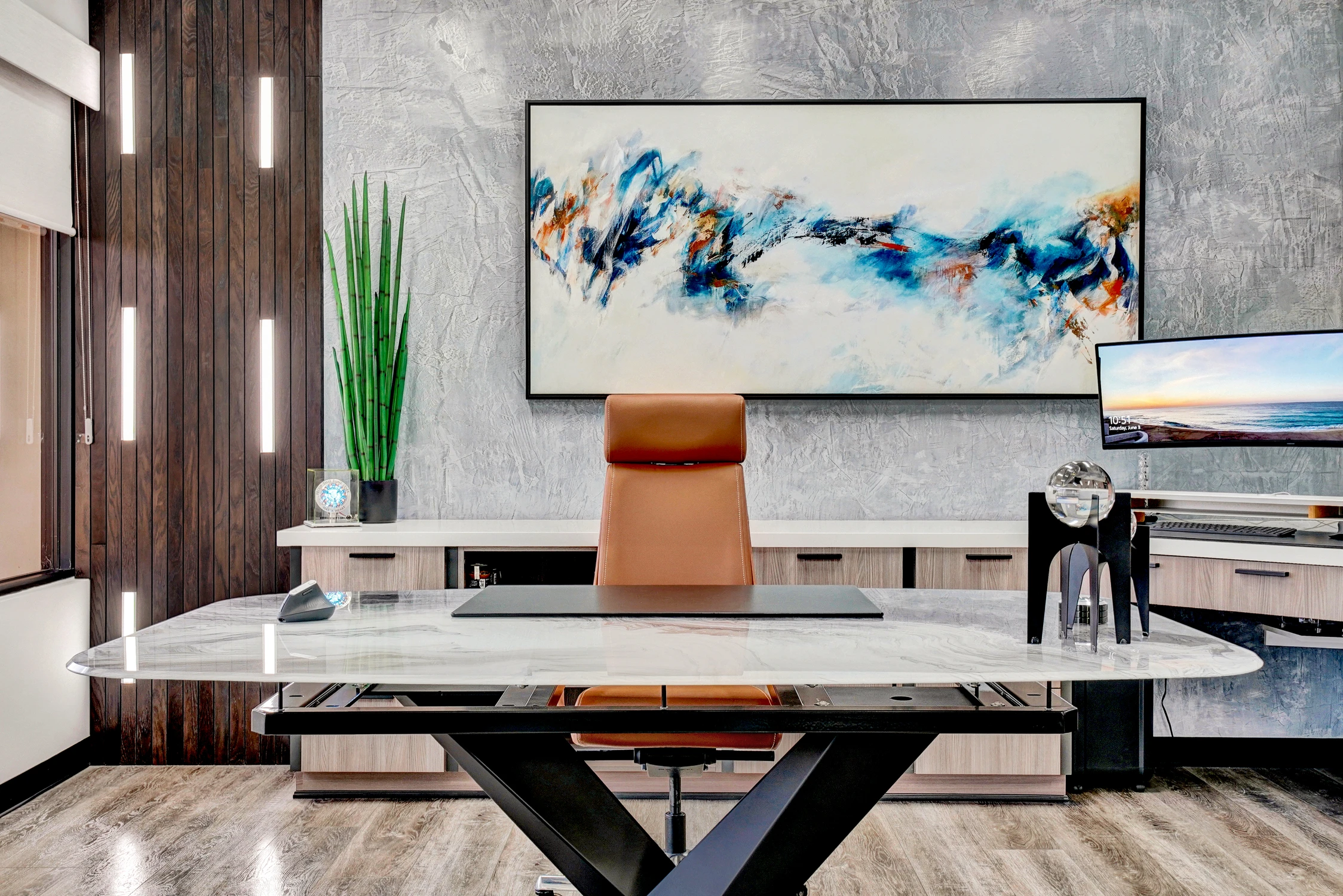 Executive office with marble-topped desk and abstract artwork