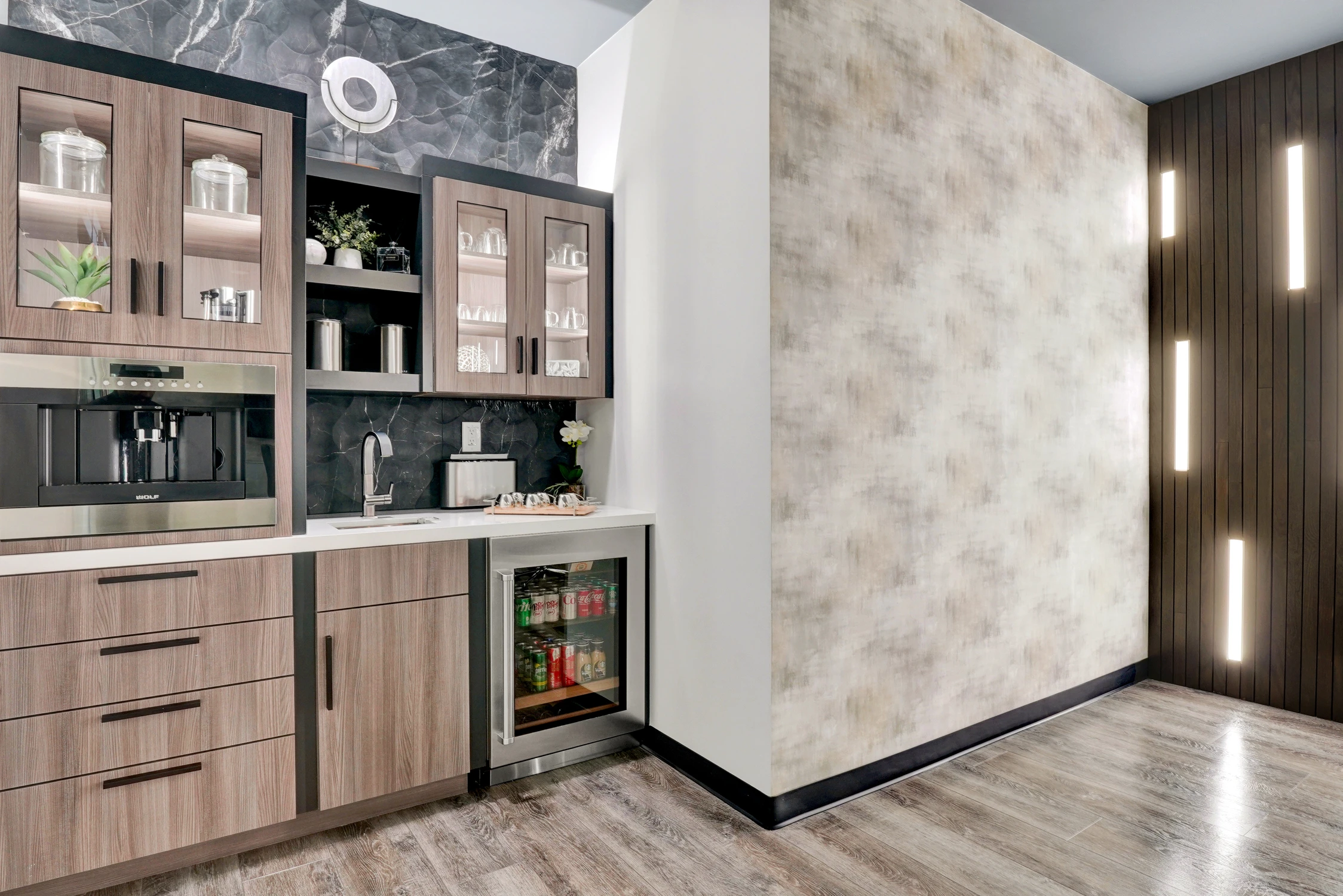 Beverage cabinet beside textured wall and vertical light panel