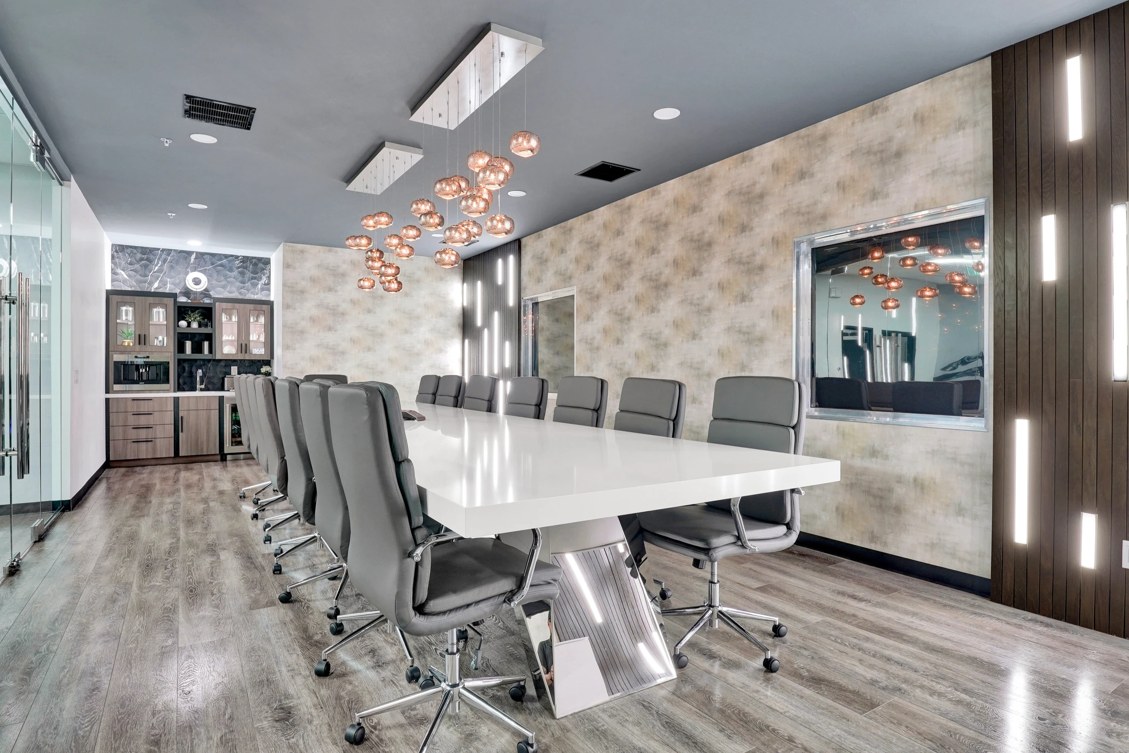 Conference room with white table, beverage cabinet, and glass partitions