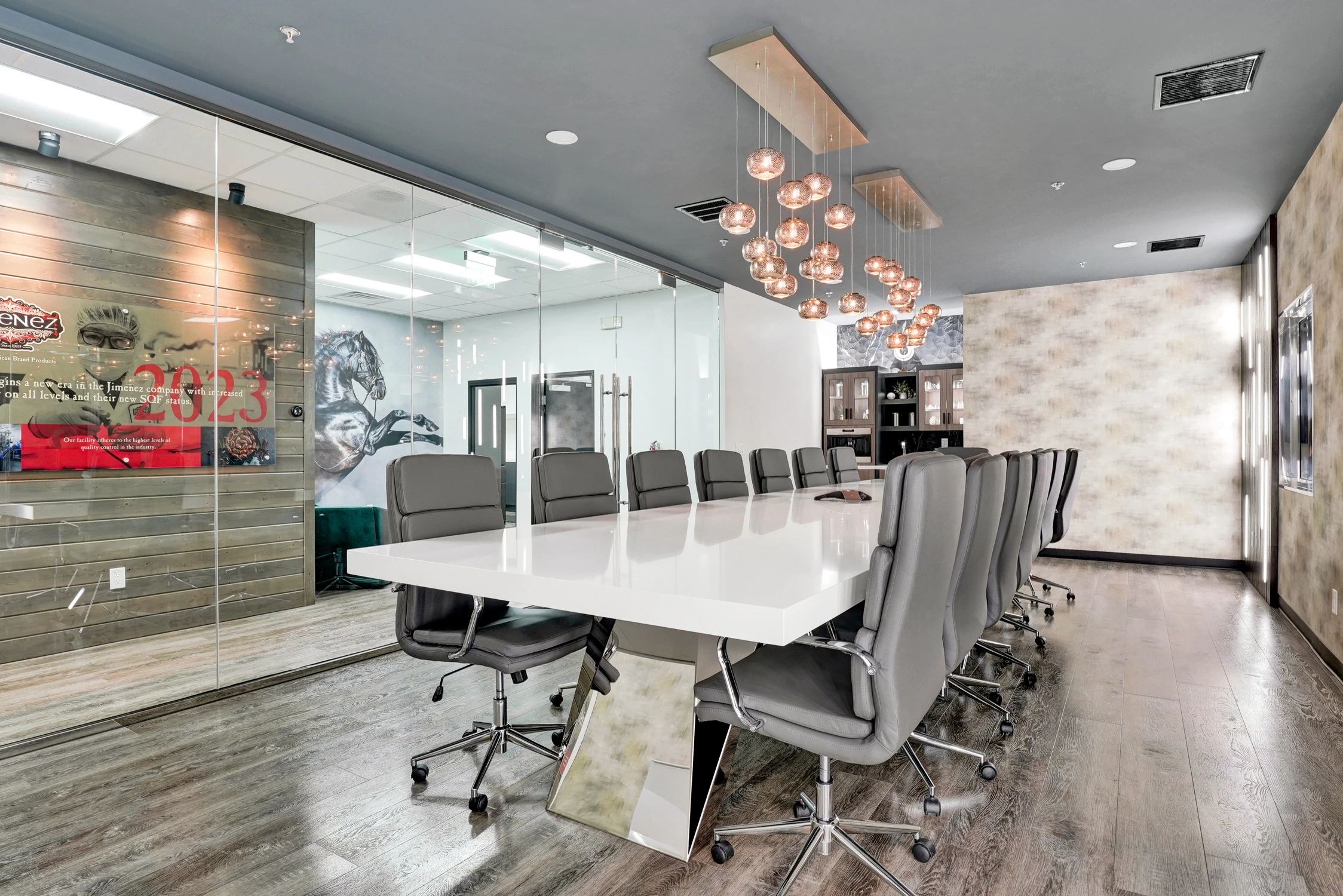 Long conference table beside glass wall with horse mural