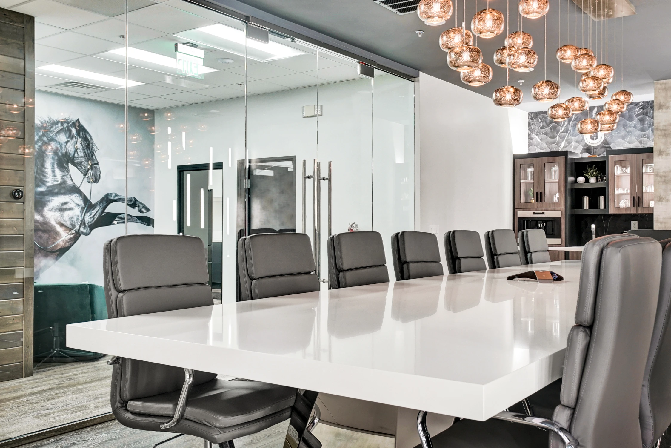 Conference table with horse mural visible through glass wall