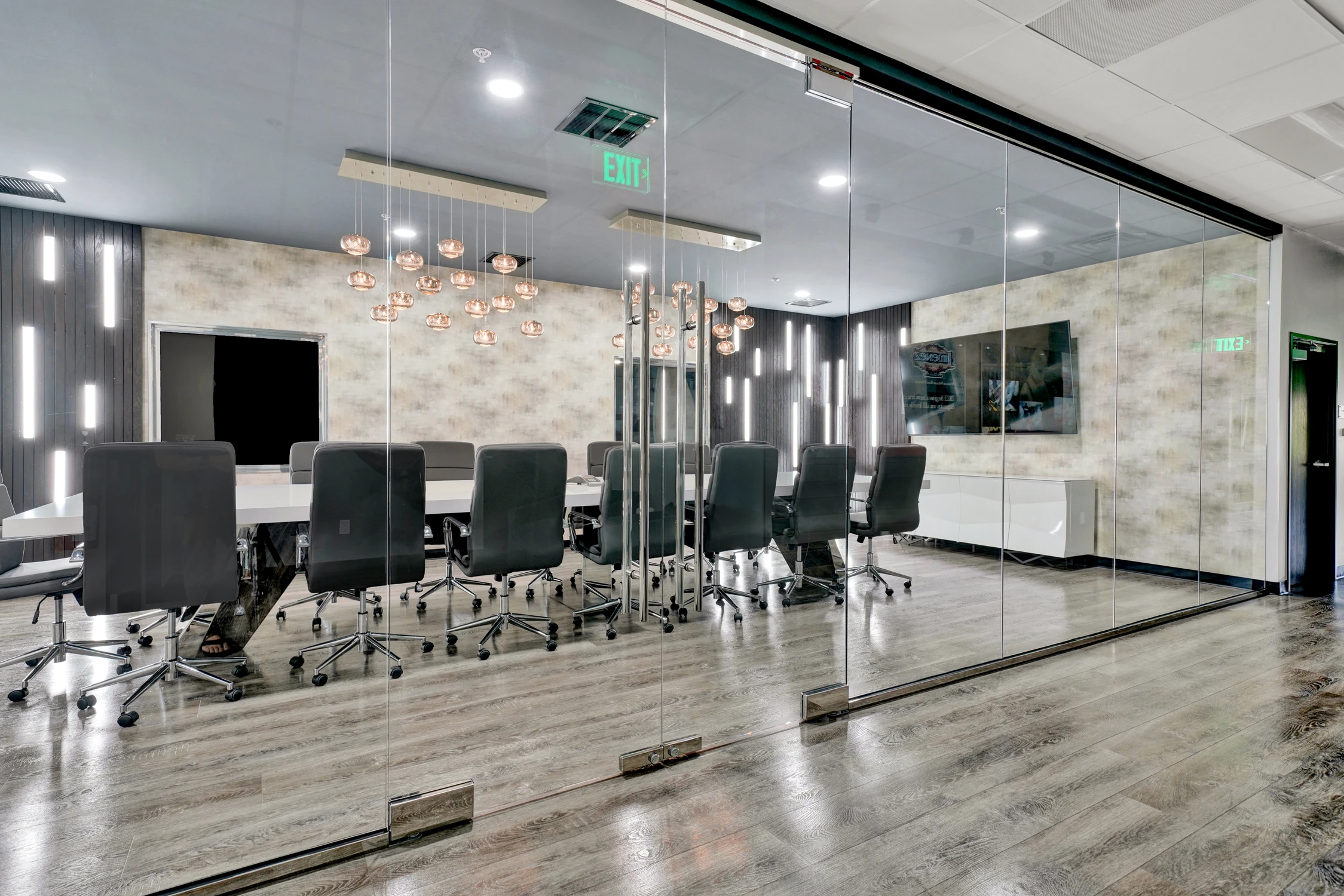 Teal lounge chairs beside horse mural and mirrored hallway wall