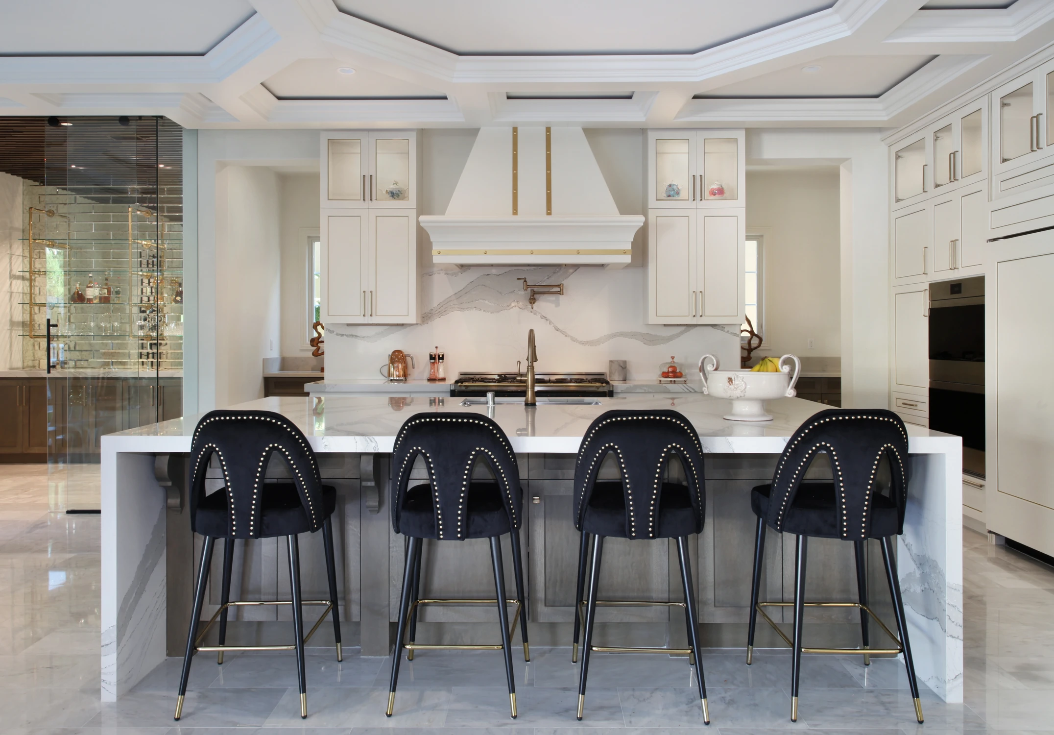 White kitchen with black stools and large island