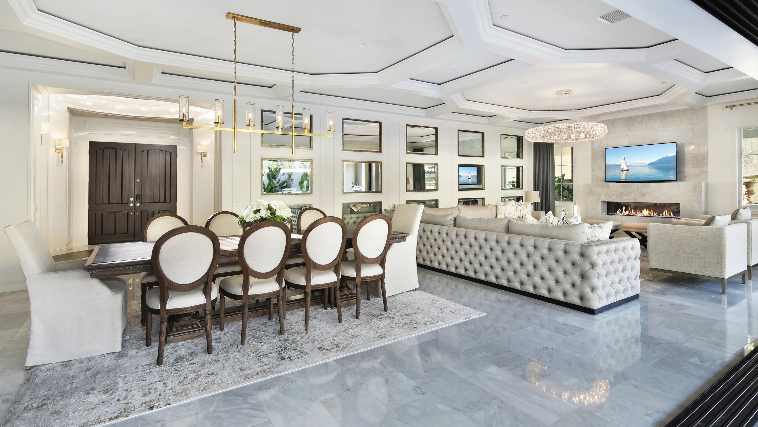 Open dining and living room with pale seating and a geometric ceiling