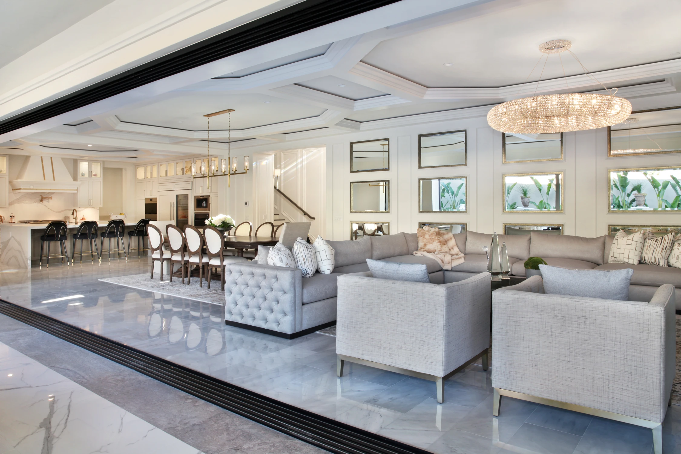Living room with pale seating and open kitchen beyond