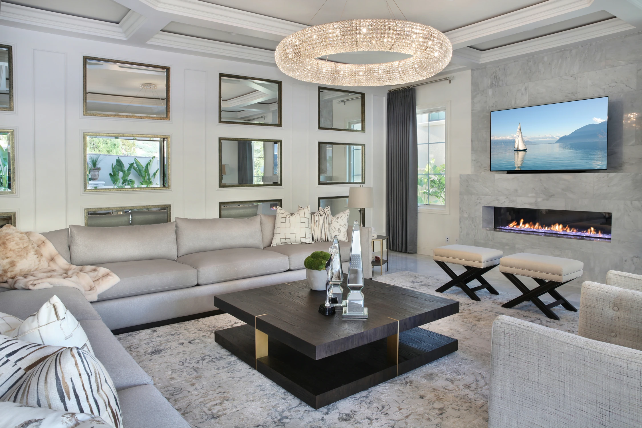 Living room with gray sectional and patterned stone fireplace