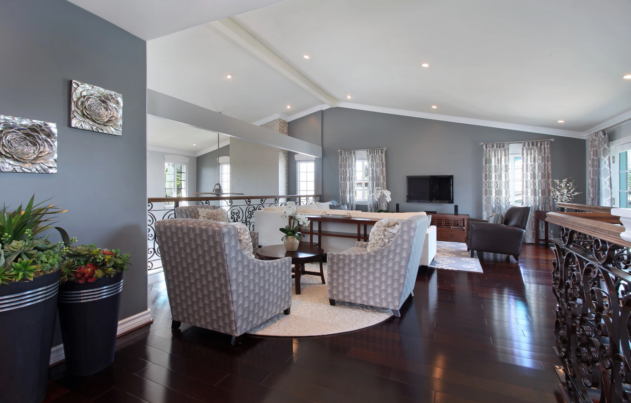 Loft seating area with patterned chairs facing an open living space