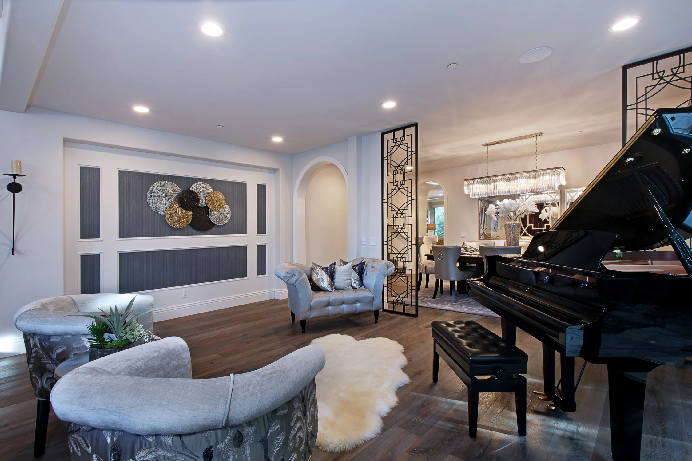 Grand piano beside open dining room with dark patterned wall panels