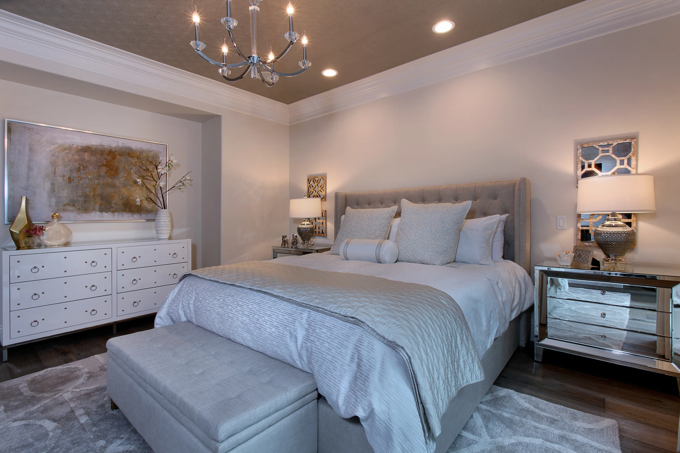 Master bedroom with pale blue bedding, dark wood floor, and chandelier