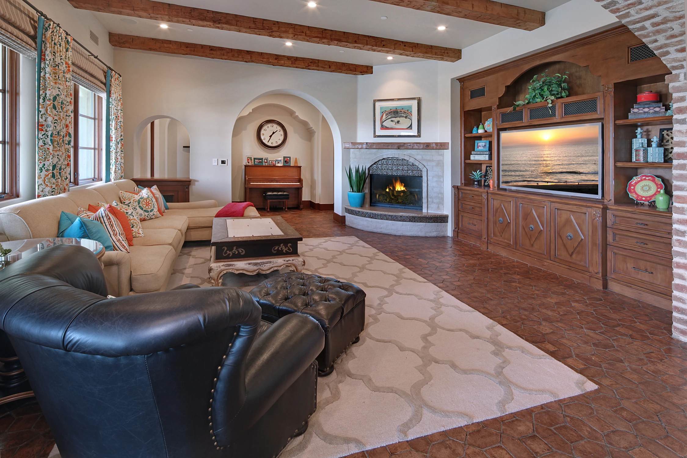 Family room with dark built-in media wall and colorful seating