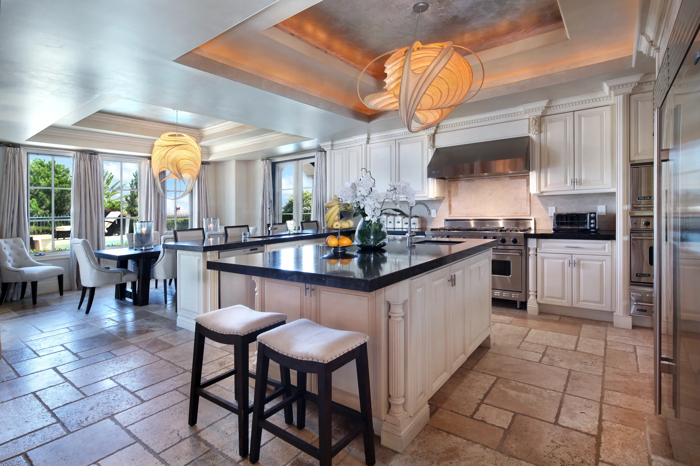 Traditional kitchen with dark island and coffered ceiling