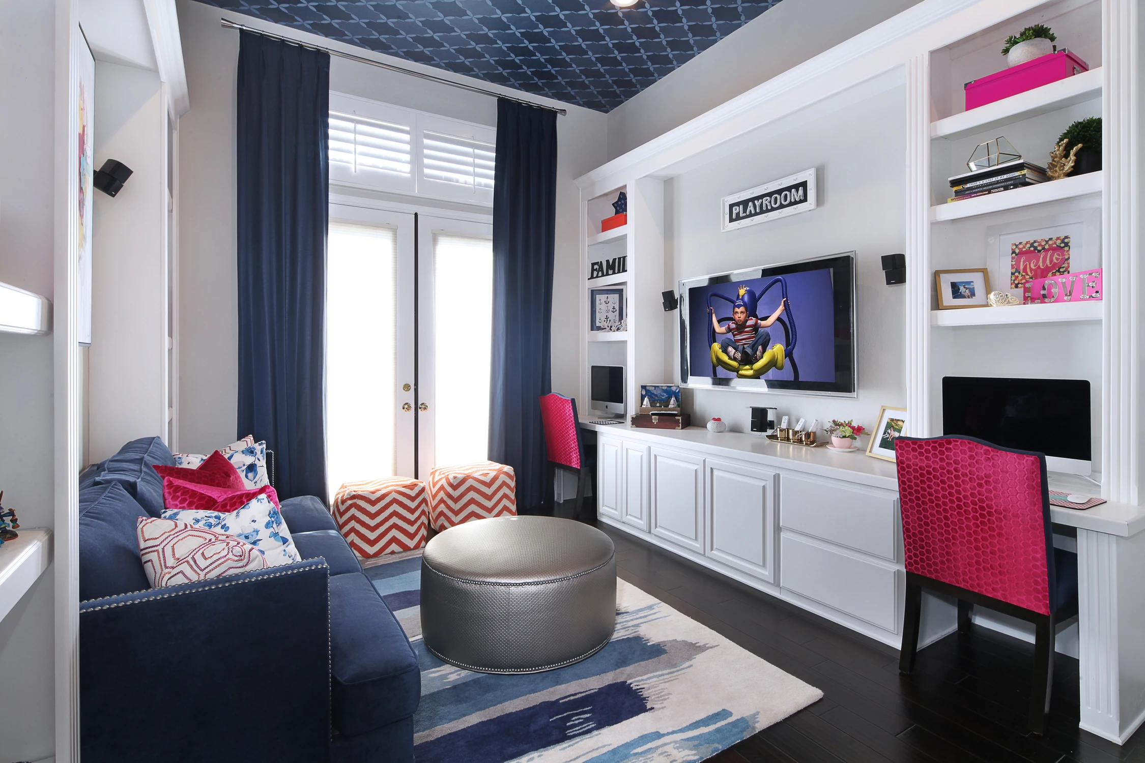 Built-in playroom shelves with navy seating and red chairs