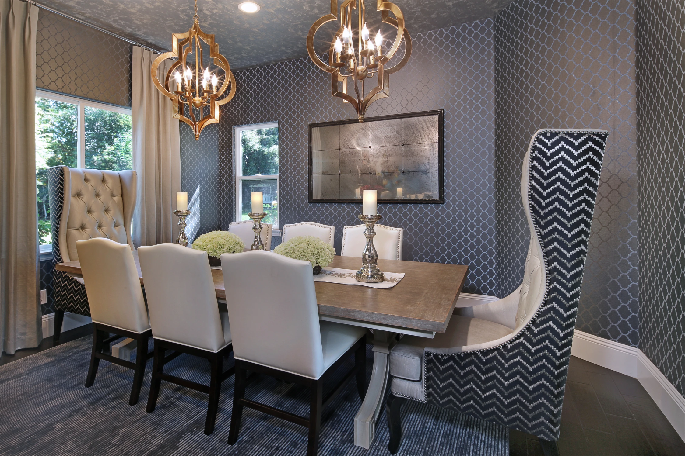 Dining room with dark wallpaper and upholstered chairs