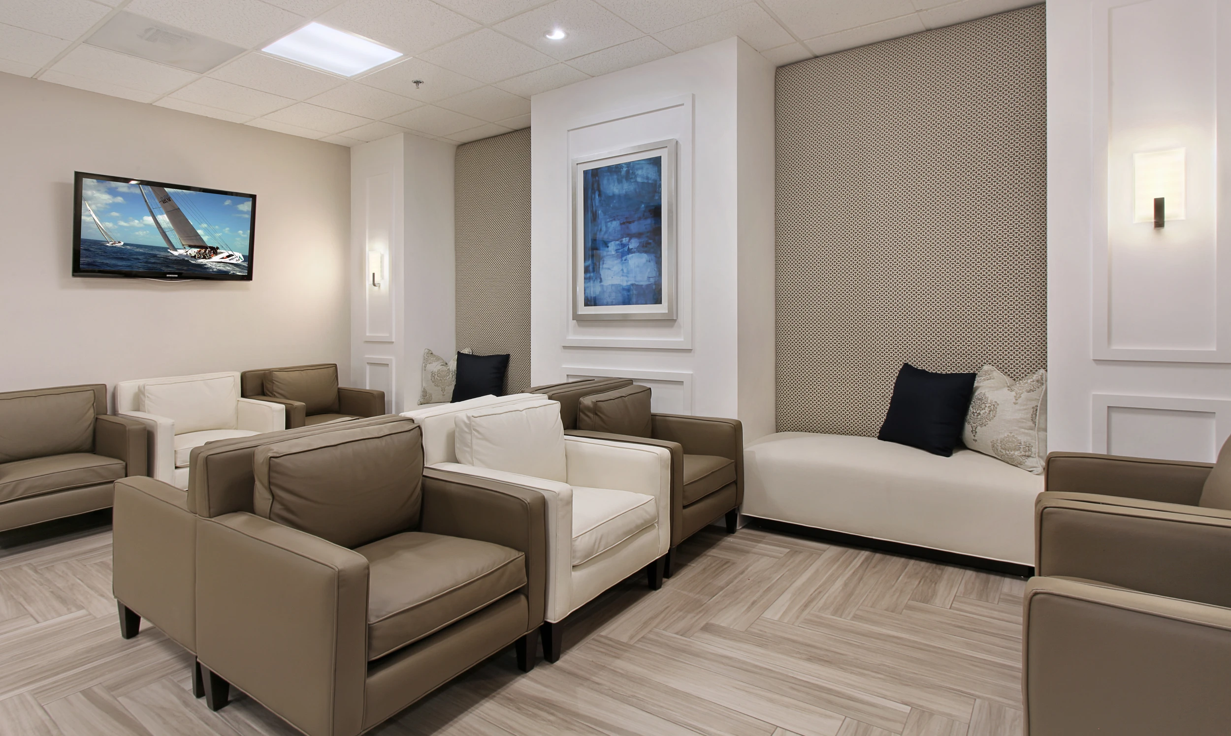 Medical office waiting room with neutral chairs and layered wall panels