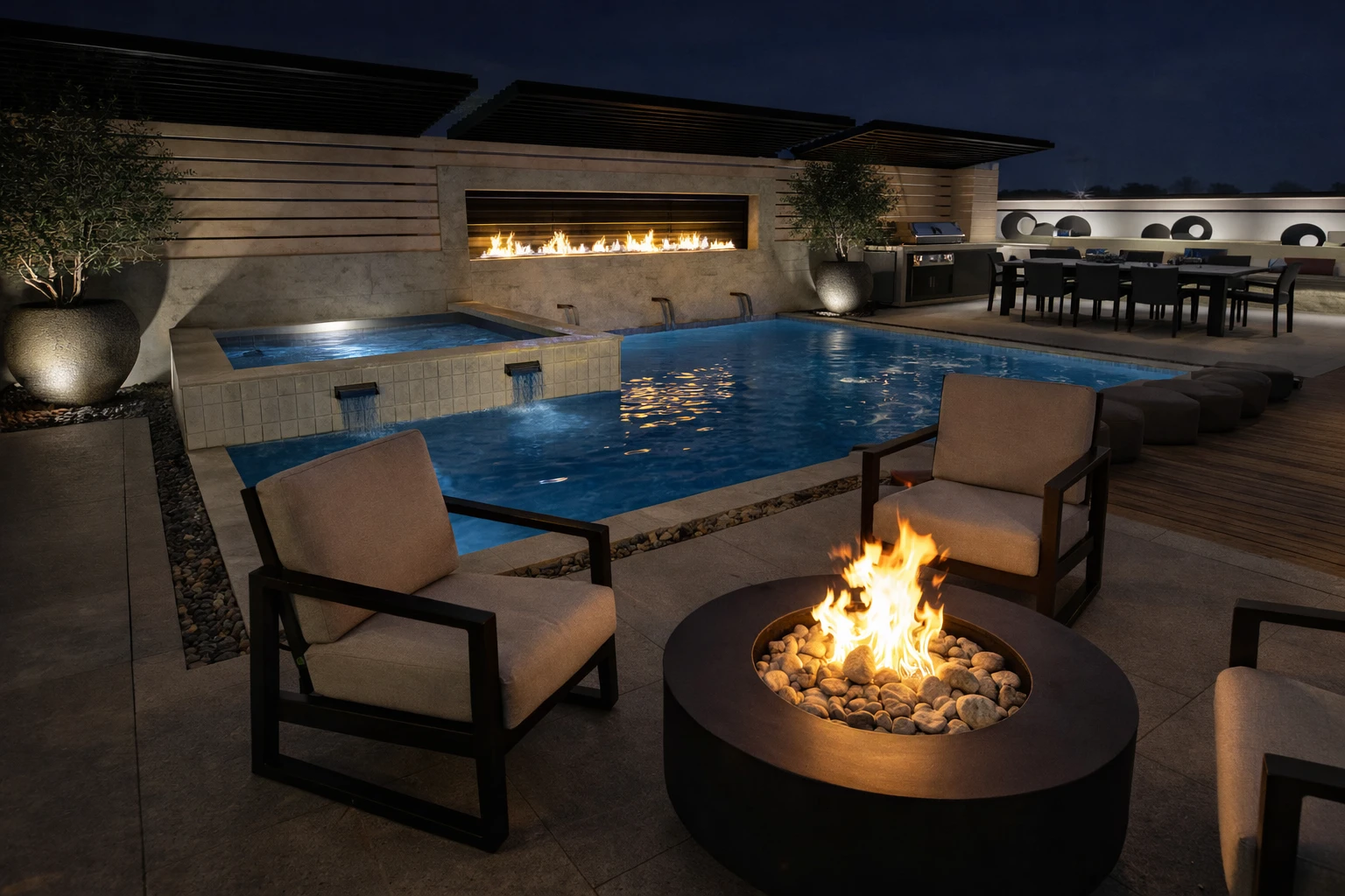 Nighttime pool and hot tub, with a fireplace, outdoor dining area, and fire pit