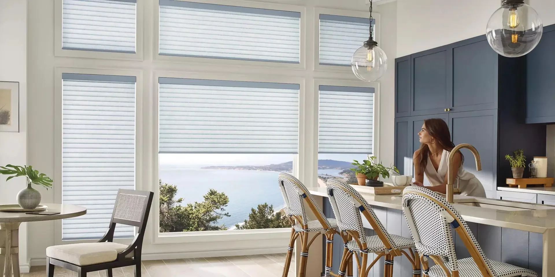 Light-filtering shades in a blue and white kitchen