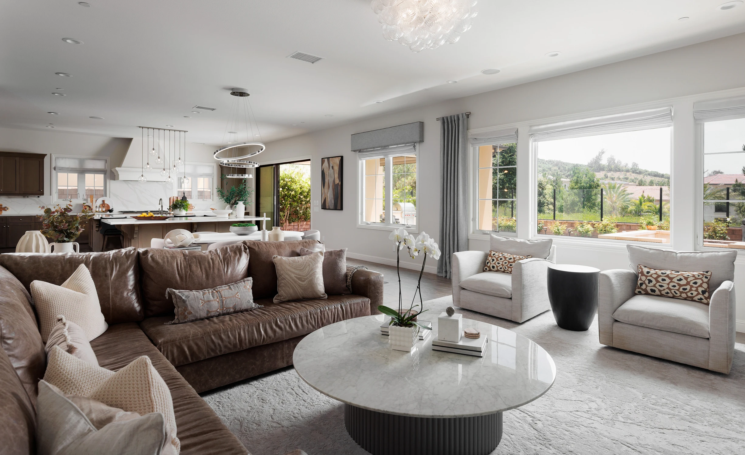 Living room with leather sofa and hillside view