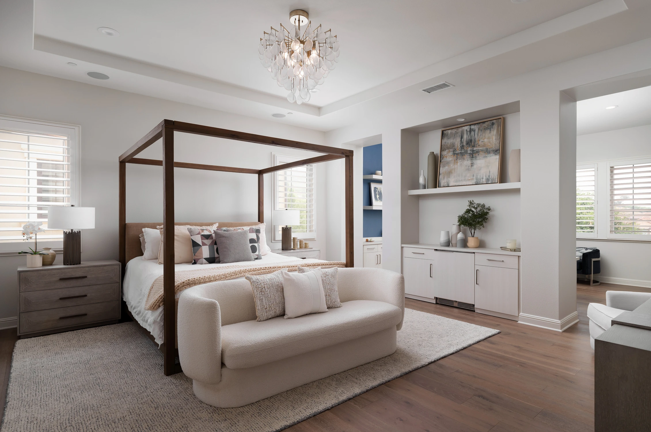 Bedroom with four-poster bed, seating, and built-in cabinetry