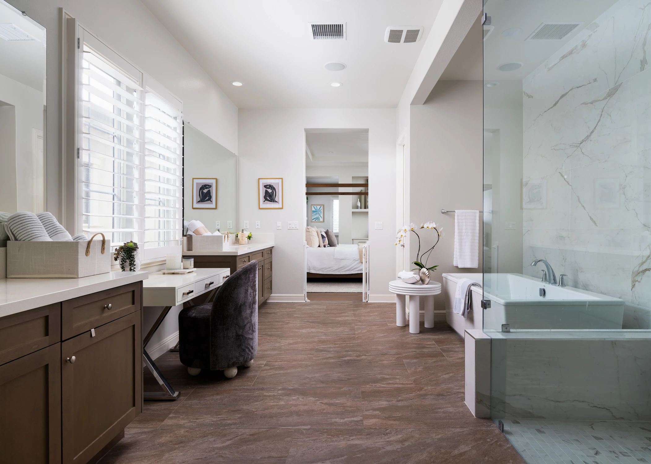 Master bathroom with vanity, desk, and glass shower