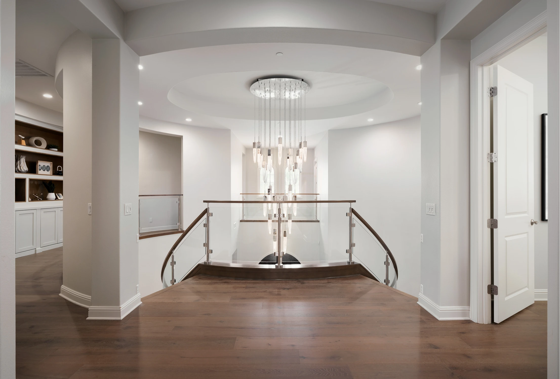 Upper hallway overlooking the illuminated stair hall