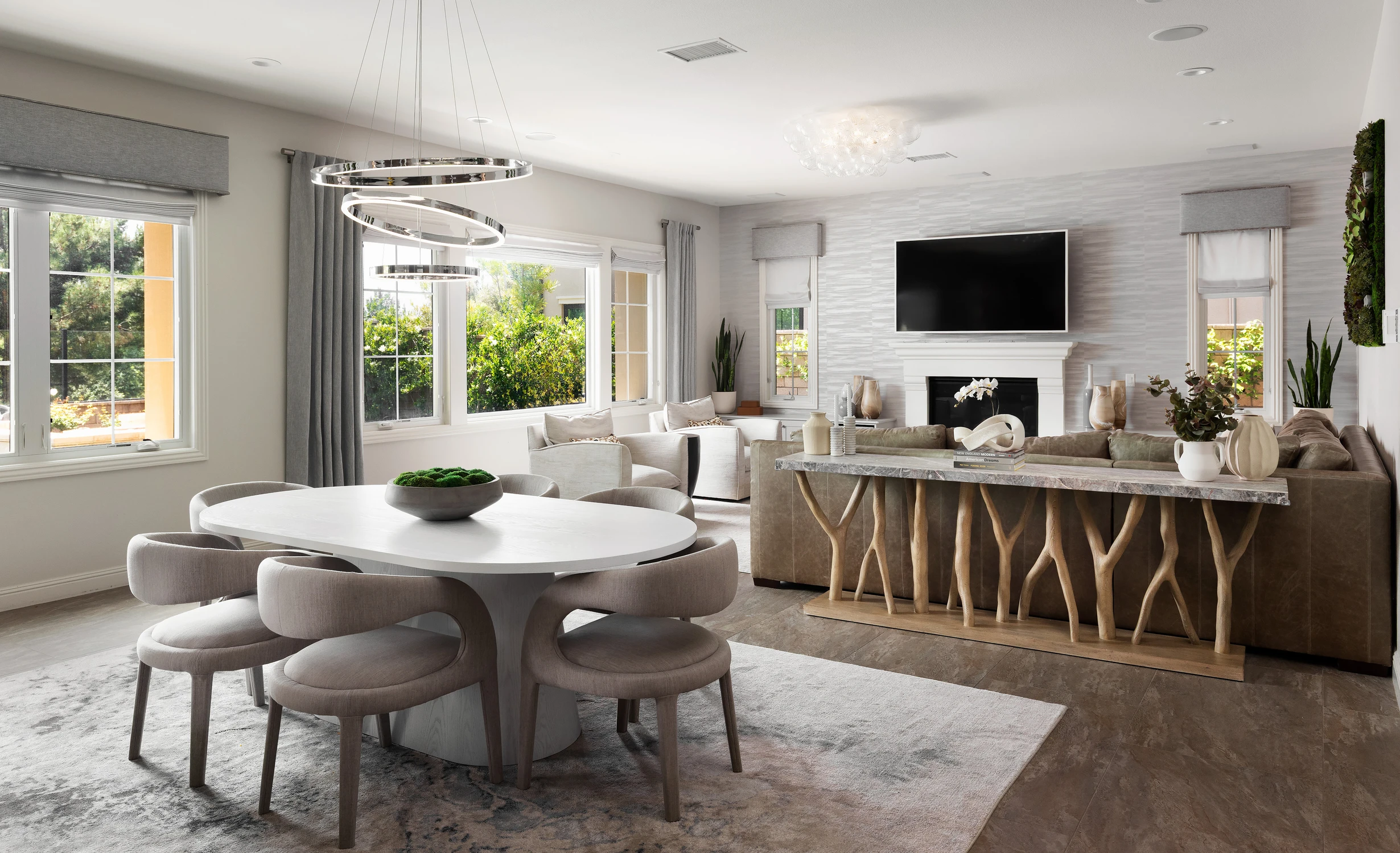 Open-plan living room with white fireplace and sculptural wood console