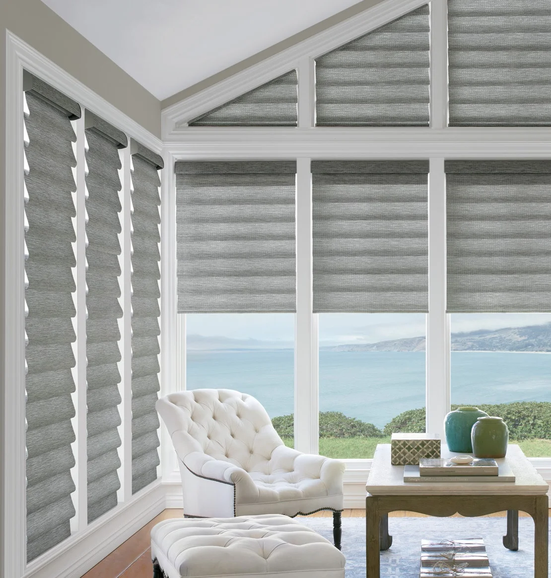 Gray shades on tall angled living room windows